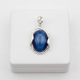 Blue cat's eye 59.50ct gemstone pendant in silver setting on a white box