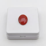 natural red agate carnelian aqeeq 28.00ct Red gemstone on a white box against a white background