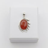 natural red agate carnelian aqeeq 31.15ct Silver pendant with a red stone on a white background