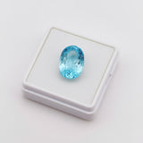 swiss blue topaz round stone 43.70ct Blue gemstone on a white display box against a light gray background