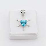 swiss blue topaz round stone 29.20ct Silver pendant with a blue gemstone on a white background