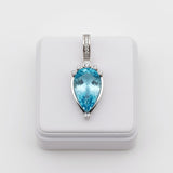 swiss blue topaz round stone 33.75ct Blue teardrop pendant with silver frame on a white background