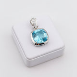 swiss blue topaz round stone 39.85ct Silver pendant with a blue gemstone on a white background