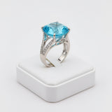 swiss blue topaz round stone 39.85ct Silver ring with a blue gemstone on a white background