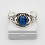 61.80ct cat eye stone Silver bracelet with a blue stone on a white background