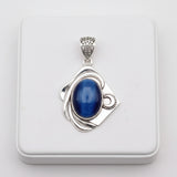 61.80ct cat eye stone Silver pendant with a blue stone on a white background