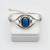 cat eye stone 58.40ct Silver bracelet with a blue stone on a white background