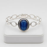 cat eye 59.50 ct Silver bracelet with a blue stone on a white background