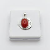 natural red agate carnelian aqeeq 33.65ct Silver pendant with a red stone on a white background