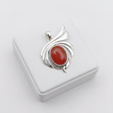 natural red agate carnelian aqeeq 37.10ct Silver pendant with a red stone on a white background