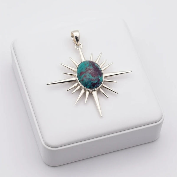 nishapur turquoise 61.55ct Silver sunburst pendant with a colorful stone on a white box