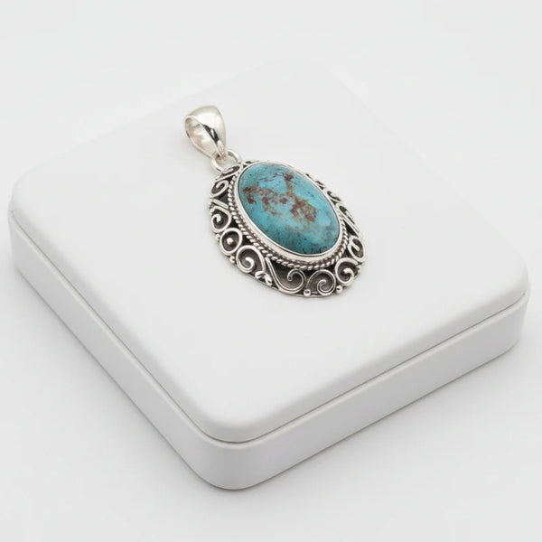 nishapur turquoise stone 37.90ct pendant with silver setting on a white box