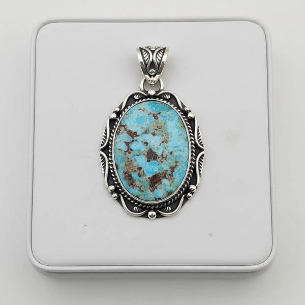 nishapur turquoise 61.00ct  pendant with silver frame on a white background