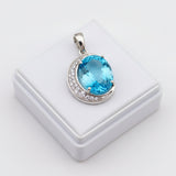 swiss blue topaz round stone 29.05ct Blue gemstone pendant with silver frame on a white box