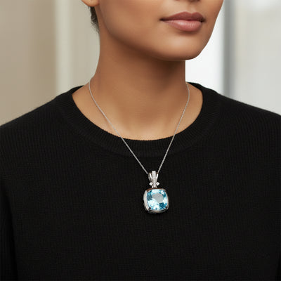 swiss blue topaz round stone 39.85ct  Person wearing a necklace with a blue pendant against a neutral background