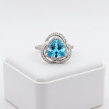 swiss blue topaz round stone 29.20ct Silver ring with a blue gemstone on a white background