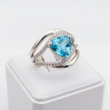 swiss blue topaz trillion 31.60ct Silver ring with a blue gemstone on a white background