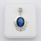 Blue cat's eye 58.55ct Silver pendant with a blue stone on a white background