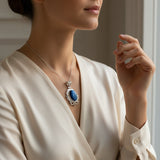Blue cat's eye 58.55ct Woman wearing a necklace with a blue pendant in a neutral setting