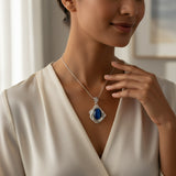 61.80ct cat eye stone Woman wearing a necklace with a blue pendant in a softly lit room