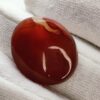 polished reddish-orange Carnelian gemstones, also known as Irani Aqeeq or Yemeni Haqeeq, displayed on a white background, showcasing their smooth cabochon cuts and vibrant natural color.