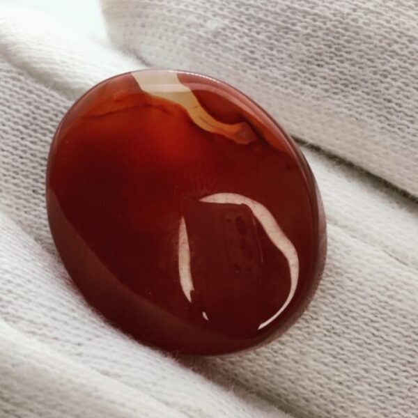 polished reddish-orange Carnelian gemstones, also known as Irani Aqeeq or Yemeni Haqeeq, displayed on a white background, showcasing their smooth cabochon cuts and vibrant natural color.
