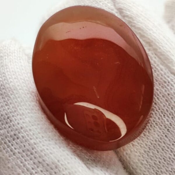 polished reddish-orange Carnelian gemstones, also known as Irani Aqeeq or Yemeni Haqeeq, displayed on a white background, showcasing their smooth cabochon cuts and vibrant natural color.