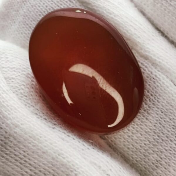 polished reddish-orange Carnelian gemstones, also known as Irani Aqeeq or Yemeni Haqeeq, displayed on a white background, showcasing their smooth cabochon cuts and vibrant natural color.